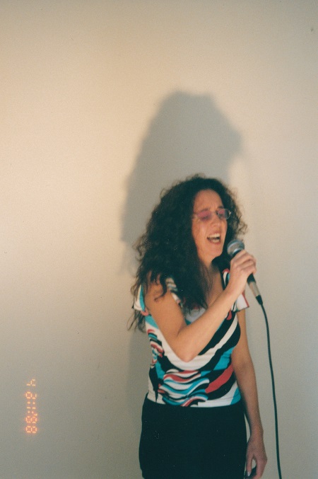 front shot singing into a mic