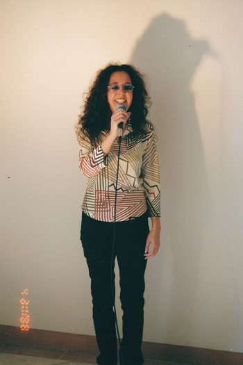 A full height front on shot of Terri singing